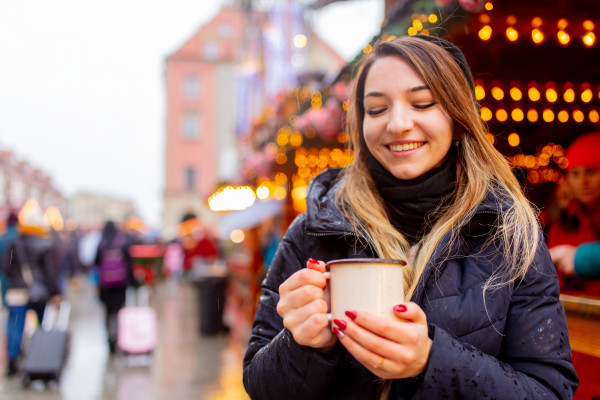 young-woman-with-cup-on-in-christmas-market